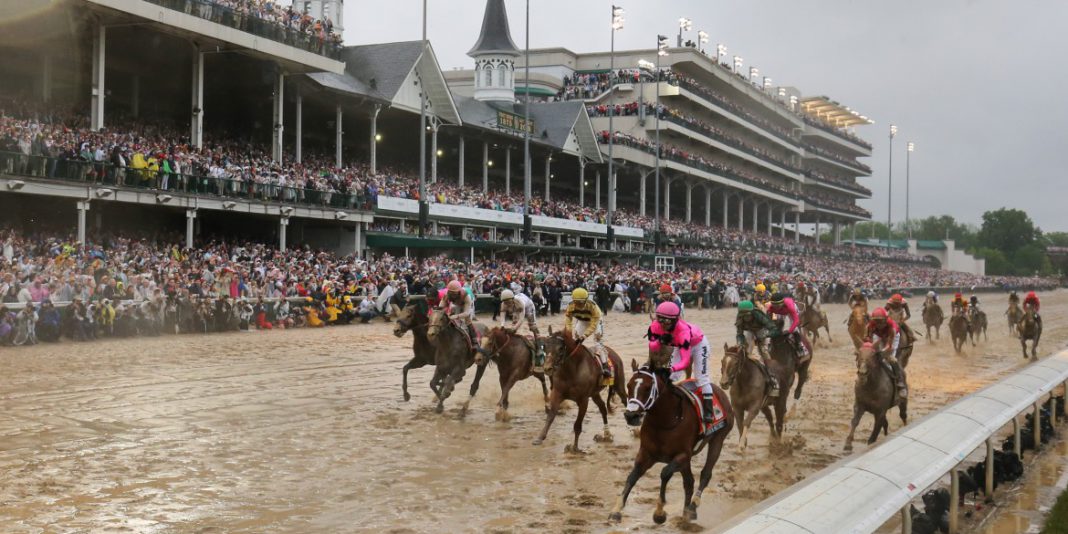 Horses race around a race track