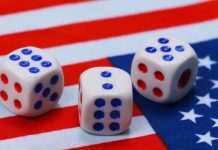 Patriotic dice on an American flag implying election betting