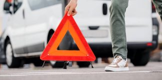 caution triangle being set on a road