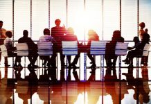 members of board sit round table - BetMakers