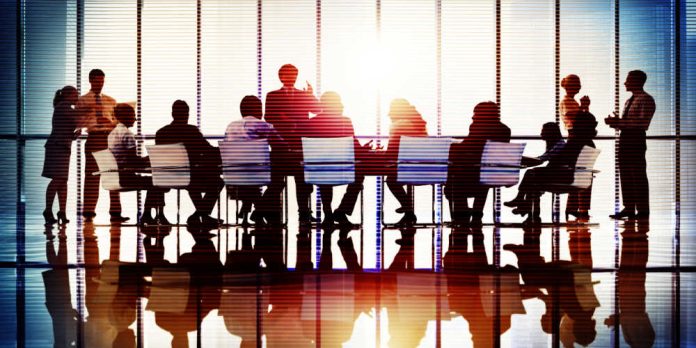 members of board sit round table - BetMakers