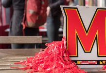 University of Maryland logo surrounded by red poms poms