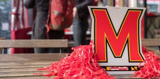 University of Maryland logo surrounded by red poms poms