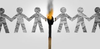 Paper people separated by a lit match