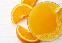 Glass of orange juice with orange rinds