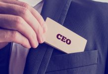 Business person holding a CEO badge