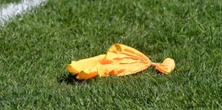 Yellow penalty flag from football