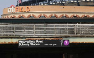Citi Field with a Willets Point subway stop sign in the foreground