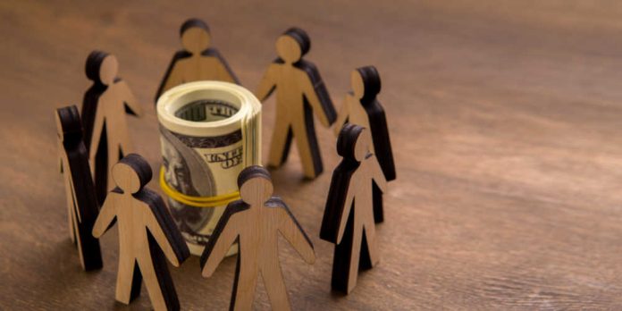 Stick figures surrounded a rubber-banded roll of money