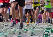 Boston Marathon runners with cups on the ground