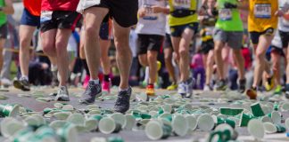 Boston Marathon runners with cups on the ground