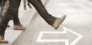 Foot taking step out into the street