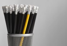 Black pencils clumped with a single yellow pencil