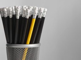 Black pencils clumped with a single yellow pencil