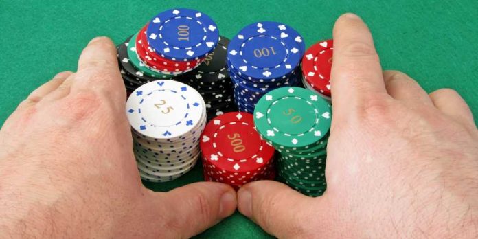 Hands pushing poker chips
