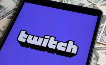 Twitch logo on phone sitting on stack of money