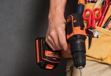 Man with drill and tool belt