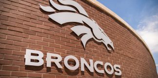 Denver Broncos logo on a brick wall