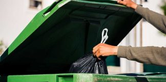 Penn ditches Barstool to launch ESPN BET sportsbook Hand putting bag in trash