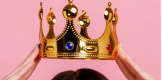 Delaware Lottery chooses Rush Street as new online gaming partner Hands putting a crown on a head