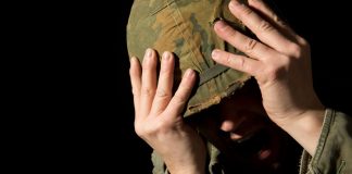Bovada under fire in new Kentucky class action suit Soldier holding helmet