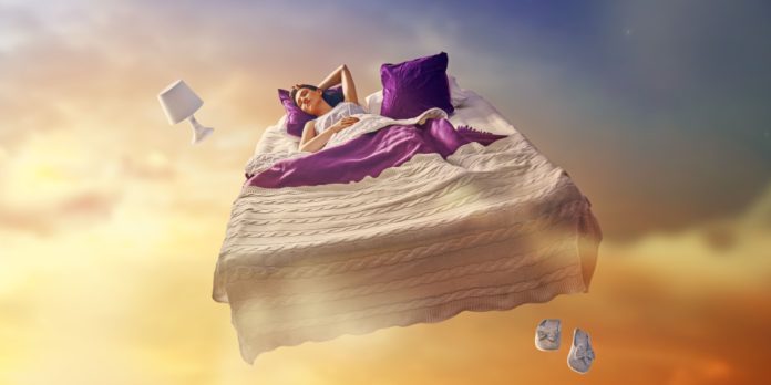 Flying bed with woman sleeping on it