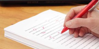 NFL revises gambling policy for players and staff Hand with red pen editing paper