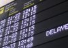Delayed flight on airport scheduling board