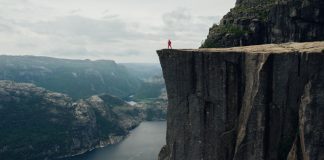 person looking over cliff edge