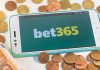 bet365 logo on a phone surrounded by money