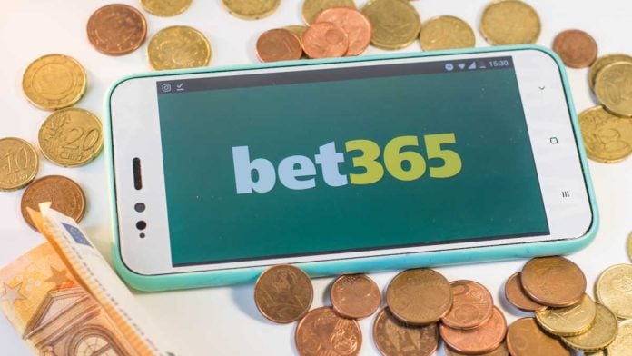 bet365 logo on a phone surrounded by money