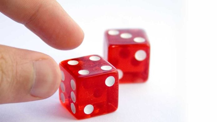 Hand picking up dice
