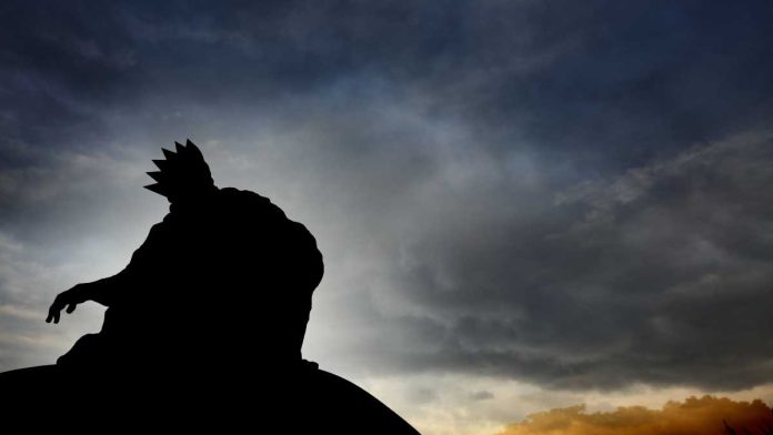 Silhouette of a king on a mountain top