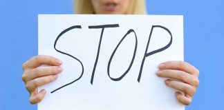 Michigan regulators send cease and desist letters to sweepstakes operators Hands holding a handwritten stop sign