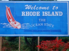 A blue sign that reads 'welcome to Rhode Island, the ocean state'.