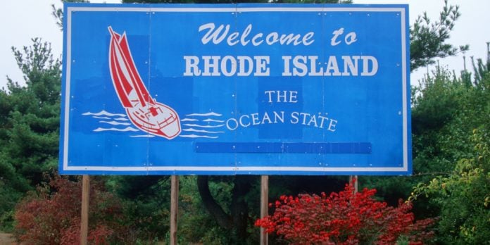 A blue sign that reads 'welcome to Rhode Island, the ocean state'.