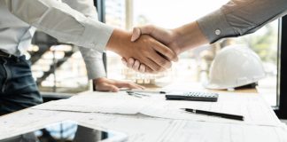 A close up of two businessmen shaking hands.
