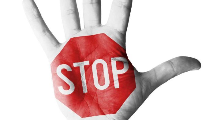 A hand with a stop sign logo on it