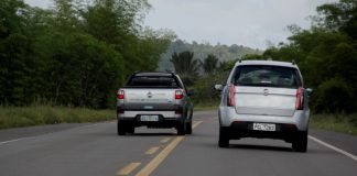 A pick up truck overtakes a car