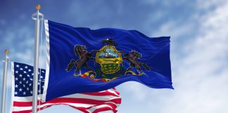 Image shows the Pennsylvania flag and USA flag