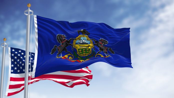 Image shows the Pennsylvania flag and USA flag