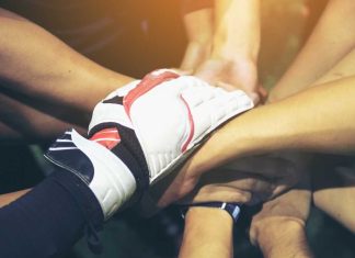 Athlete hands in a huddle
