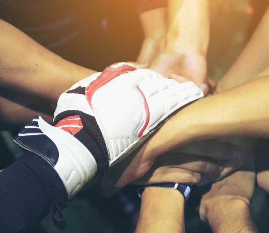 Athlete hands in a huddle