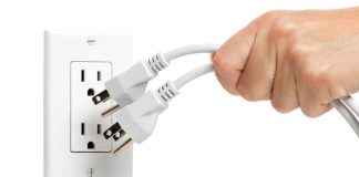Hand pulling electrical plugs