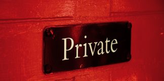 Private sign on a red brick wall