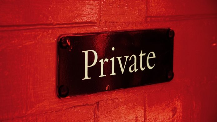 Private sign on a red brick wall