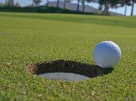 Golf ball going into hole