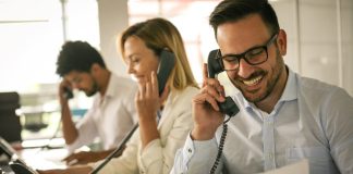 3 people making phone calls in an office
