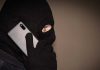 Masked man on cell phone