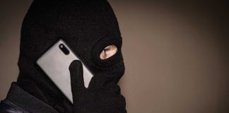 Masked man on cell phone